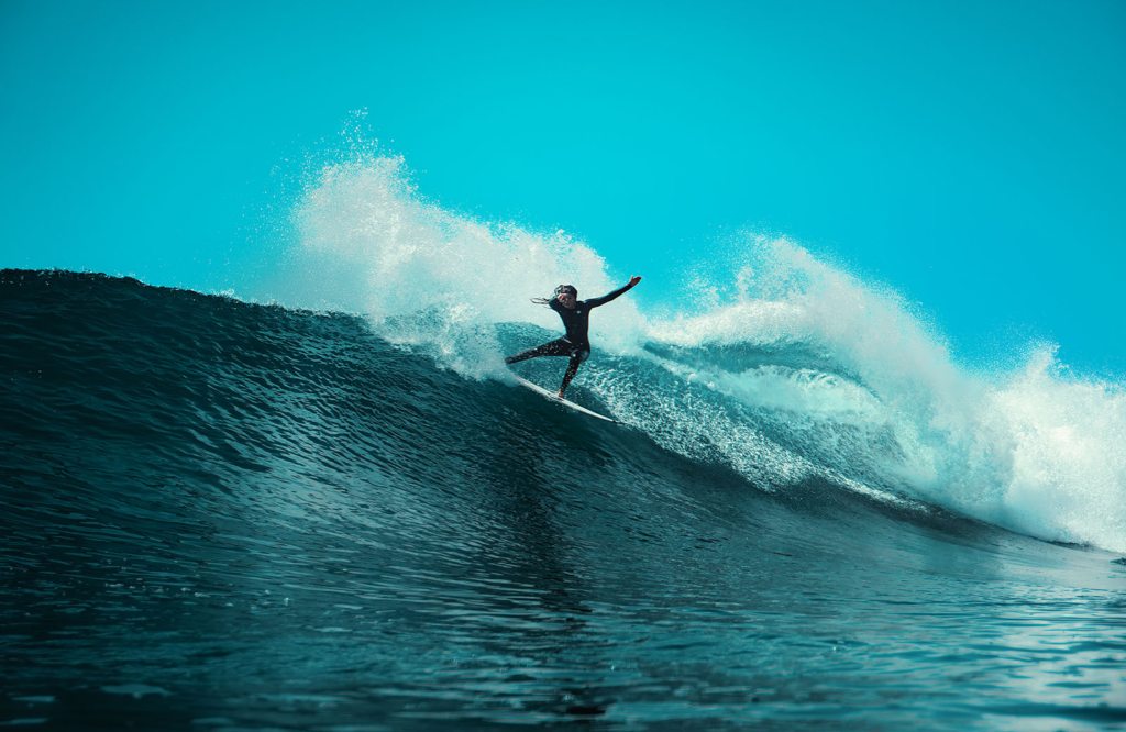 Noel Forseas, aerial drone photographer California. A woman surfing a huge wave.