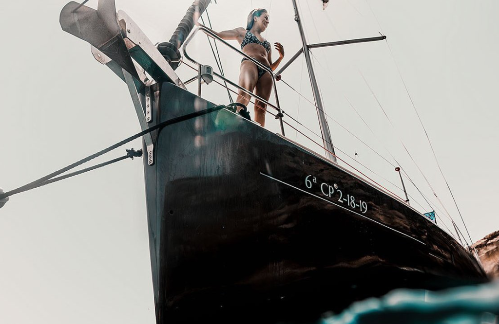 Noel Forseas, high-quality sports photographer Indonesia. A woman looking at the sea from a sailboat.